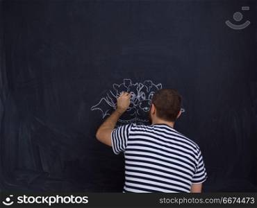 future dad drawing his imaginations on chalk board. Conceptual photo of future dad drawing his imaginations about the future life with children on chalk board