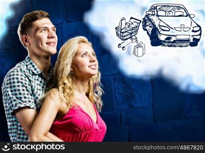 Future plans. Young happy couple dreaming about buying car