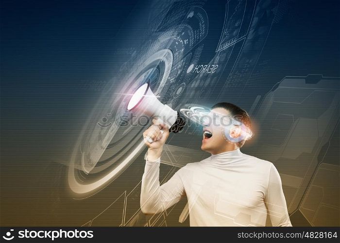 Future technologies. Young man in white screaming in megaphone against media background
