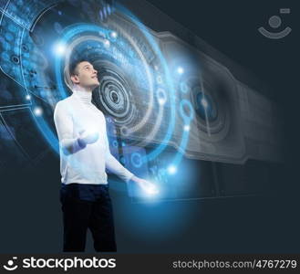 Future technologies. Young man in white touching icon of media screen