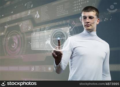 Future technologies. Young man in white touching icon of media screen