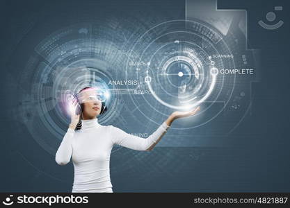 Future technologies. Young pretty asian woman touching digital hologram