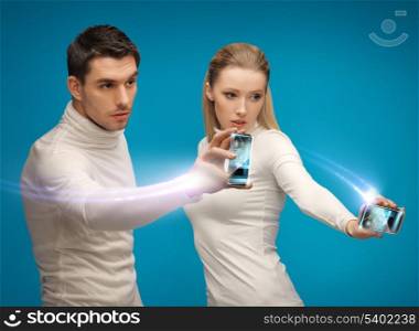 future technology and science fiction - futuristic man and woman working with gadgets