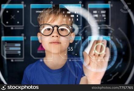 future technology, augmented reality and cyberspace concept - happy smiling boy in glasses touching virtual projection over white illumination in dark room. boy in glasses over illumination in dark room