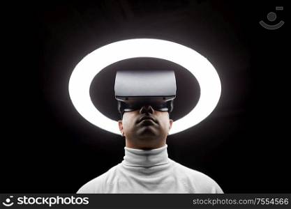 future technology, augmented reality and people concept - man in virtual reality headset or vr glasses under white illumination over black background. man in virtual reality headset or vr glasses