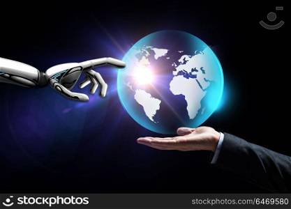 future technology, business and artificial intelligence concept - close up of businessman hand and robot touching virtual earth hologram over black background. human and robot hand with virtual earth hologram