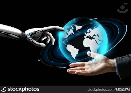 future technology, business and artificial intelligence concept - close up of businessman hand and robot touching virtual earth hologram over black background. human and robot hand with virtual earth hologram. human and robot hand with virtual earth hologram