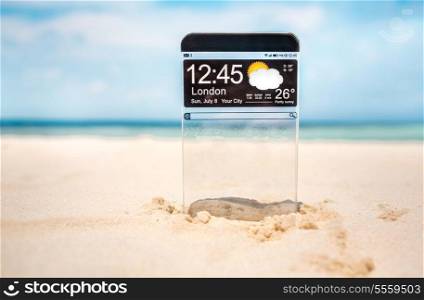 Futuristic Smart phone (copy space display) with a transparent display in the sand on the beach. Concept actual future innovative ideas and best technologies humanity.