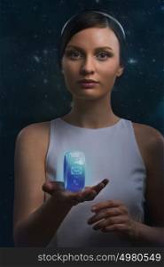 Futuristic woman holding the smart watch on a cosmic background