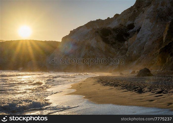 Fyriplaka beach and waves of Aegean sea on sunset, Milos island, Cyclades, Greece. Fyriplaka beach on sunset, Milos island, Cyclades, Greece