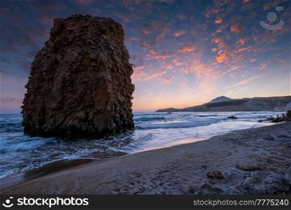 Fyriplaka beach and waves of Aegean sea on sunset, Milos island, Cyclades, Greece. Fyriplaka beach on sunset, Milos island, Cyclades, Greece