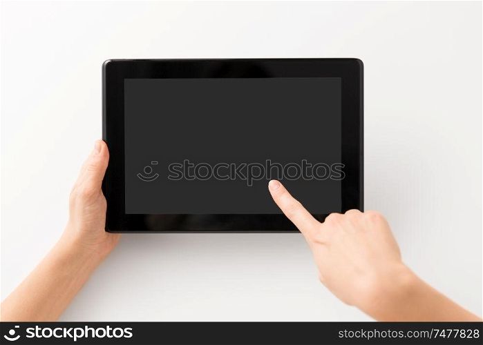 gadget and technology concept - close up of hands with black tablet computer smartphone. close up of hands with black tablet computer