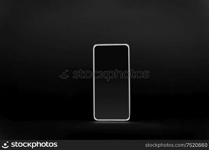gadget, technology and electronics concept - smartphone with blank screen on black background. smartphone with blank screen on black background
