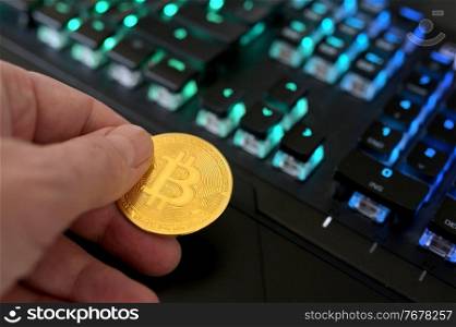 Galati, Romania - April 09, 2021 Studio shot of golden Bitcoin virtual currency on a computer keybopard