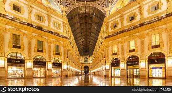 Galleria Vittorio Emanuele II in Milan, Italy. Milan, Lombardia, Italy - October 24, 2017: One of the world's oldest shopping malls Galleria Vittorio Emanuele II from inside the arcade at night in Milan