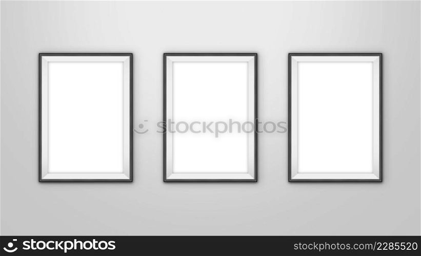 Gallery interior with three empty frames for pictures on wall. With clipping path