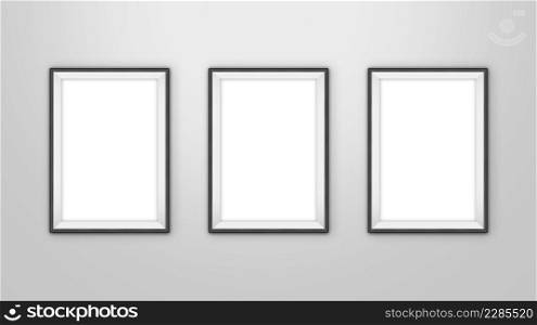 Gallery interior with three empty frames for pictures on wall. With clipping path