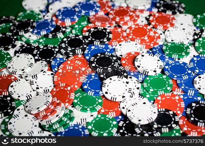 gambling, fortune, game and entertainment concept - close up of casino chips background