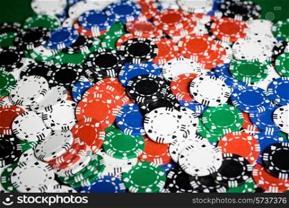 gambling, fortune, game and entertainment concept - close up of casino chips background