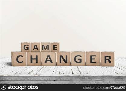 Game changer sign made of wooden blocks on a desk in a bright room