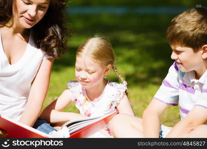 Game in park. Image of children with nurse playing in park