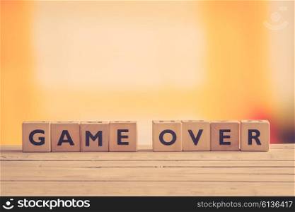 Game over sign on a table in retro colors