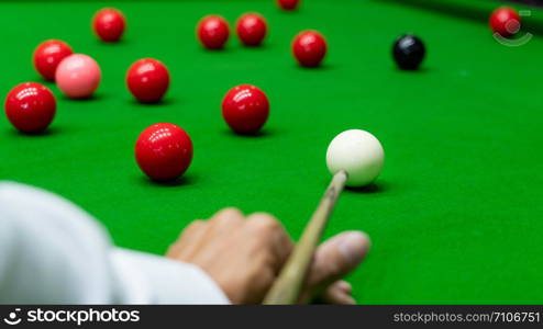 Game snooker billiards or opening frame player ready for the ball shot, athlete man kick cue on the green table in bar