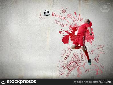 Game strategy. Football player in jump striking ball with sketches at backdrop