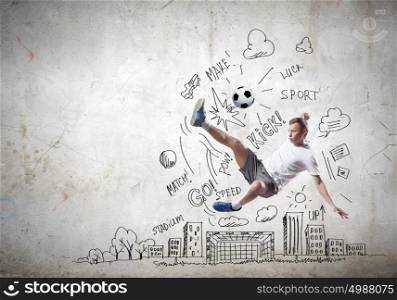 Game strategy. Football player in jump striking ball with sketches at backdrop