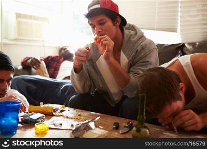 Gang Of Young Men Taking Drugs Indoors