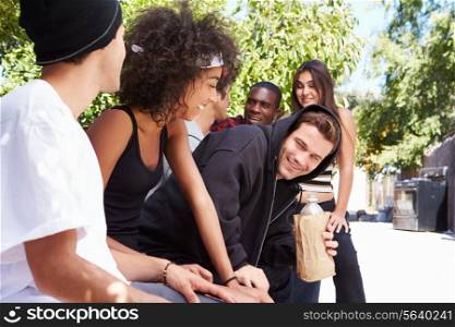 Gang Of Young People In Urban Setting Drinking Alcohol