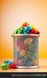 Garbage bin with paper waste isolated on white