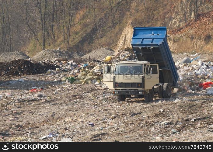 Garbage machines unload garbage on a municipal dump
