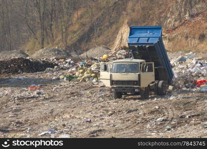 Garbage machines unload garbage on a municipal dump