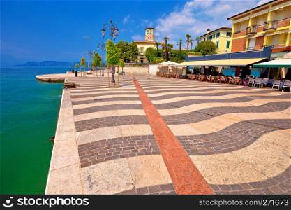 Garda lake turquoise waterfront in town of of Lasize view, Veneto region of Italy