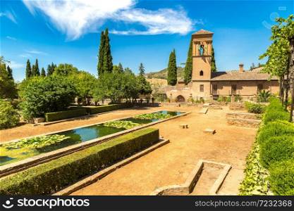 Garden and Bell Tower in Alhambra palace in Granada in a beautiful summer day, Spain