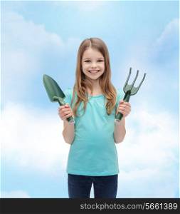 garden and people concept - smiling little girl with rake and scoop