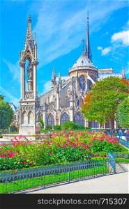 Garden and rear of the Notre Dame de Paris on sunny day, France