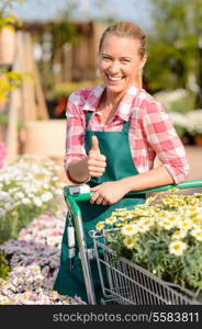 Garden center smiling woman with colorful potted flowers thumb up
