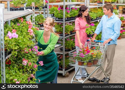 Garden center worker pushing flower shelves customers shopping