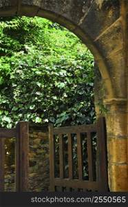 Garden gate in medieval town of Sarlat, Dordogne region, France