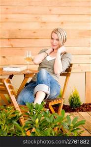 Garden happy woman enjoy glass wine sitting on terrace