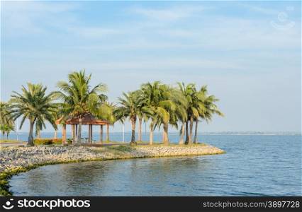 Garden pavillion with coconut palm tree on the shore