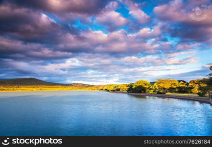 Garden Route in sunny day, beautiful landscape of a lake and mountains with fluffy clouds over it, panoramic view, amazing nature of South Africa