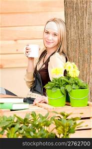 Garden woman terrace enjoy cup of coffee in spring garden