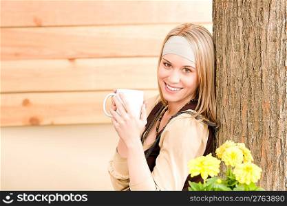 Garden woman terrace enjoy cup of coffee in spring garden