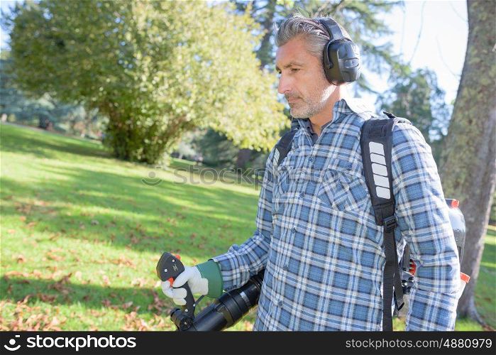 garden worker using a leaf blower