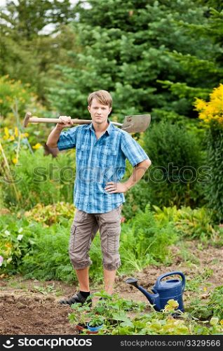 gardener digging the soil in spring with a spade to make the garden ready