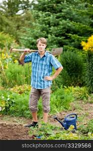 gardener digging the soil in spring with a spade to make the garden ready