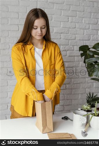 gardener preparing gift with plant